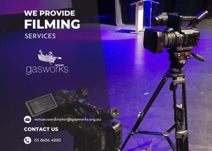 Image of two cameras in a theatre space, featuring white text 'we provide filming services' including contact information. 