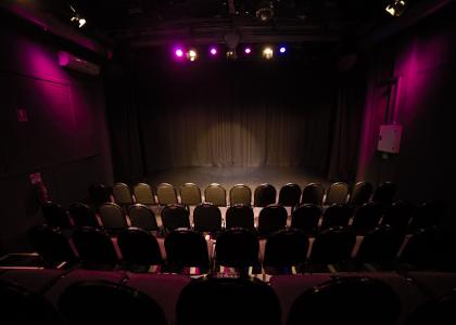 A view of the studio theatre from the back row looking at the stage. 