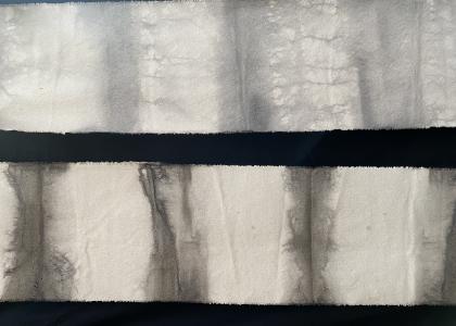Two strips of grey striped fabric dyed with plants
