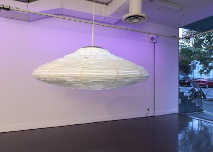 Lantern shaped like UFO hanging in a purple space