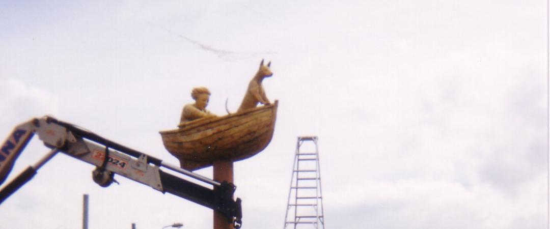 An action shot of the Man, Dog, Boat sculptures being erected. 